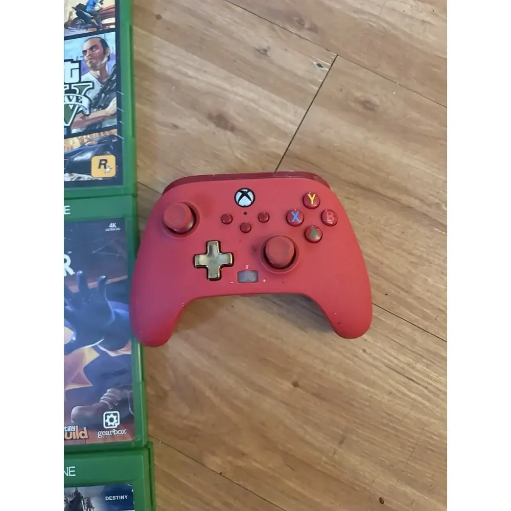 6 Xbox One games with a red wireless controller.